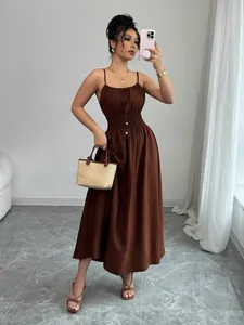 Elegant brown sleeveless smocked waist maxi dress with spaghetti straps on model