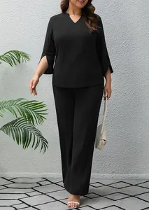Detail view of plus size black two-piece set with V-neck top and wide-leg trousers