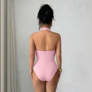 Back view of a slim-fit pink halter-neck bodysuit with a backless design for women