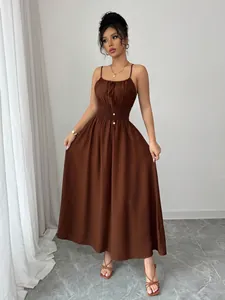Elegant brown spaghetti strap maxi dress with a smocked waist and gold button details