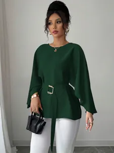 Full body shot of an elegant dark green French retro flare sleeve blouse with a waist belt.