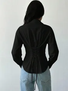 Detailed back view of a slim-fit black shirt featuring a stylish lace-up corset design.
