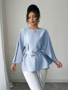 Elegant light blue French vintage style blouse with flared sleeves and belted waist