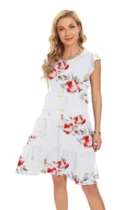 Close-up of red rose floral print on a white tiered summer dress with ruffle sleeves