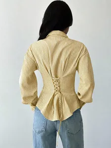 Rear view of a yellow striped shirt featuring an elegant lace-up corset back detail