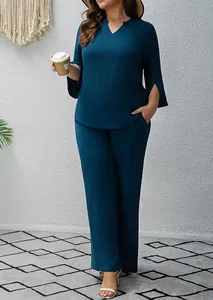 Full body view of a woman wearing a stylish dark teal slit-sleeve two-piece set