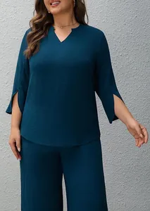 Teal two-piece set featuring split sleeve top and wide-leg trousers with textured fabric