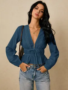 Deep V-neck blouse with lace trim, elastic waist tie, and ruffled peplum hem.