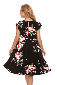 Back view of casual black tiered cake dress with vibrant red floral print detail.