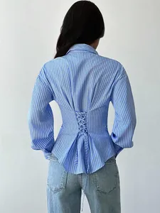 Back detail view of blue striped shirt with corset-style lace-up waist design