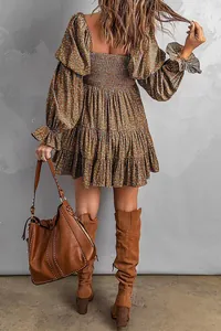 Detailansicht der Rückseite eines braunen gestuften Off-Shoulder-Minikleides mit Blumen.