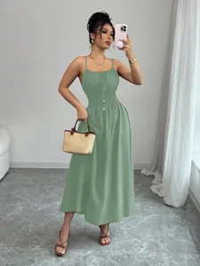 Full length shot of a sage green smocked waist midi sundress with spaghetti straps