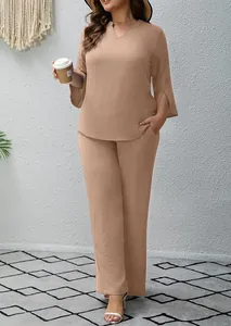 Woman wearing casual two-piece solid color V-neck top and matching wide-leg trousers