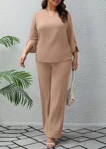 Full view of women's casual solid color two-piece set with wide-leg pants and textured top