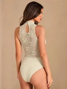 Back view of elegant white sleeveless bodysuit with intricate floral lace detail and high neck