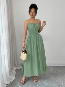 Elegant sage green sleeveless maxi dress with a smocked waist and thin spaghetti straps