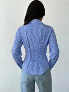Back view of blue striped long-sleeve shirt with corset-style lace-up waist detail