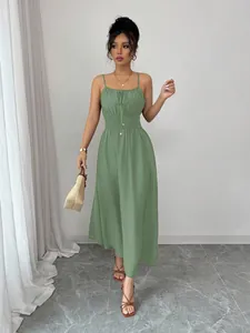 Close-up of elegant sage green midi dress featuring smocked waist and drawstring detail