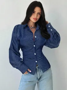 Detailed view of blue striped shirt with cinched waist and button-down front