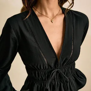 Elegant black deep V-neck blouse with lace trim, cinched waist and tie peplum hem