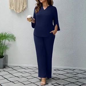 Elegant navy blue two-piece loungewear set with a V-neck top and wide-leg trousers.
