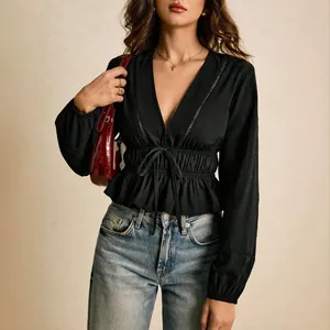 Elegant black deep V-neck long sleeve blouse featuring lace trim and peplum hem design