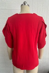 Back view of red loose blouse with ruffle bell sleeves and delicate lace trim detail