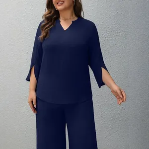 Plus size navy blue two-piece set featuring V-neck top and matching wide-leg trousers