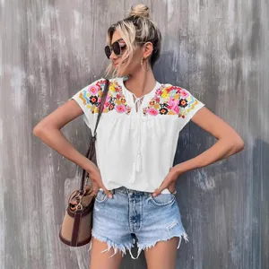 Summer white embroidered blouse with tassel tie-neck and bohemian details