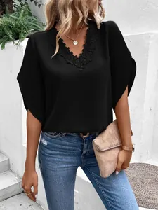 Elegant black lace V-neck blouse with bell sleeves shown in outdoor setting