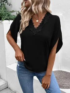 Detailed macro shot of elegant black lace V-neckline and flutter sleeves on summer blouse