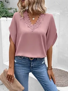 Close-up of elegant V-neck lace trim on a dusty pink loose-fit summer chiffon blouse