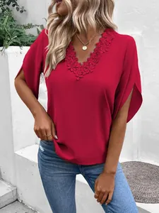 Close-up of red blouse with floral lace V-neckline and split flare sleeves