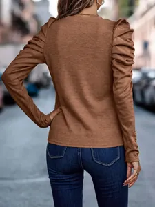 Back view detail of a brown slim fit puff sleeve knit top featuring elegant button cuffs