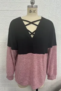 Front view of a V-neck sweatshirt with cross straps and pink colorblock design on a mannequin