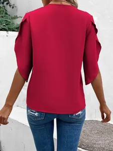 Detailed back view of a solid red loose-fitting blouse featuring elegant ruffle bell sleeves