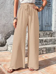 Stylish women's beige wide-leg pants featuring bubble grid texture and a high drawstring waist
