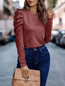 Elegant terracotta slim fit knit top with puff sleeves and gold button details on cuffs