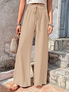 Detailed view of women's casual wide-leg pants in textured beige popcorn fabric.