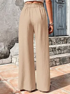 Back view detail of beige seersucker high-waist wide-leg pants with an elastic waist design