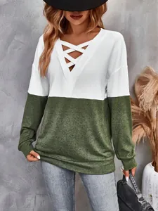 Detail view of the V-neck criss-cross straps on this two-tone color block sweatshirt.
