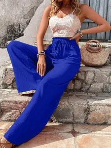 Detailed view of vibrant blue bubble-textured seersucker wide-leg pants with high waist drawstring