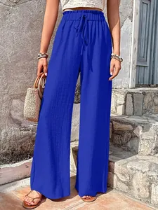 Close-up of bright blue bubble crepe wide-leg pants with elastic drawstring waist
