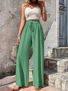 Close-up of green bubble gauze wide-leg pants with high waist and drawstring detail