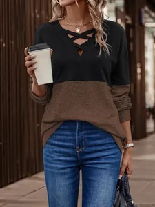 Close-up of V-neck crisscross design on color-block drop shoulder long sleeve top