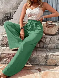 Detail of green bubble texture wide-leg casual pants worn by a model in outdoor setting