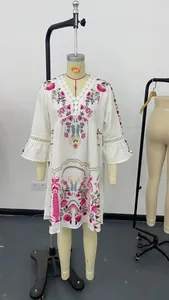 Detailed bohemian white floral print dress with lace V-neckline and bell sleeves