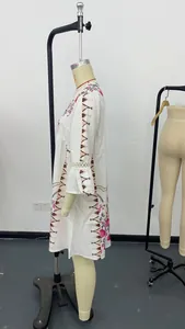Side profile of a white V-neck lace patchwork dress with vibrant ethnic floral prints