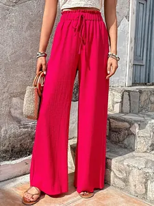 Close-up detail of hot pink bubble grid wide-leg pants featuring drawstring waist