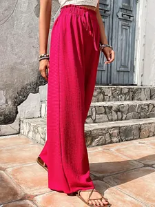 High-waisted magenta wide-leg trousers with textured bubble crepe fabric detail